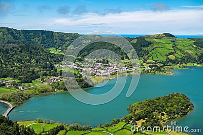 Beautiful view of the road and litle village to background volcanic lakes and forest. Stock Photo
