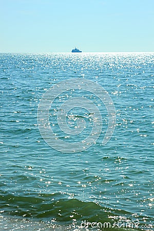 Sea travel. Beautiful view of the waves on a bright sunny day. Sun glare on the water. Ships sail away on the horizon Stock Photo