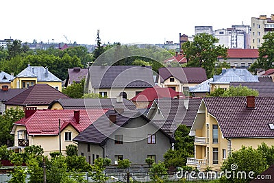 Beautiful view summer panorama of modern quiet suburban residential area. Nice comfortable two- storied new cottages with colorful Stock Photo