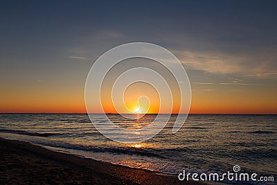 Beautiful view of sunrise in sea. Yellow and pink sky and waves in sea landscape. Sunset, dusk or dawn horizon in ocean. Summer Stock Photo