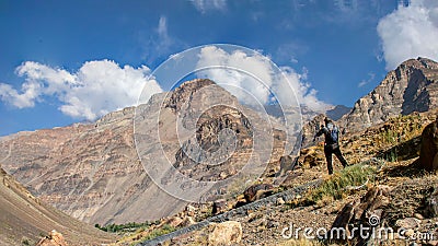 Beautiful view of a tourist taking shot of a mountain under the blue sky Stock Photo
