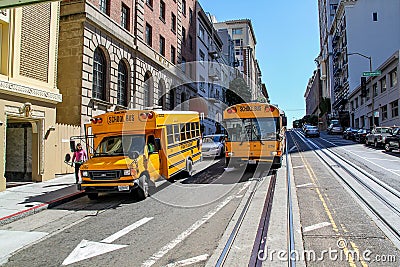 Beautiful view of two yellow school busses on street of San Francisco. Beautiful nature landscape backgrounds. Editorial Stock Photo