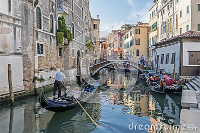 Beautiful view of a typical venetian canal, Venice, Italy, with a couple on a gondola, taking pictures and making video Editorial Stock Photo