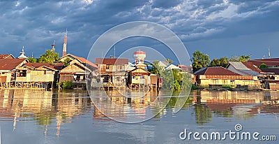 beautiful view of the village across the river. the reflection of the houses in the river water. Editorial Stock Photo