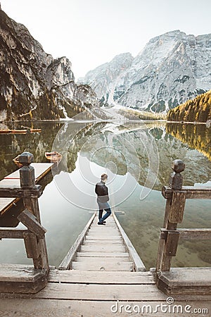 Young man watching sunrise at Lago di Braies, South Tyrol, Italy Editorial Stock Photo