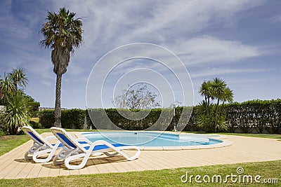 Beautiful villa with a healthy garden and a pool Stock Photo