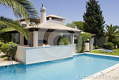 Beautiful villa with a healthy garden and a pool Stock Photo