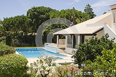 Beautiful villa with a healthy garden and pool Stock Photo