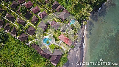 Beautiful villas, holiday bungalows, oceanfront vacation houses, swimming pool in luxury tourist resort in lush palm tree jungle Stock Photo