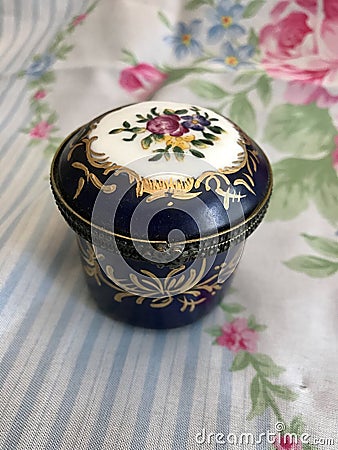 Beautiful Vintage Floral Miniature Porcelain Trinket Box with Brass Clasp and Gold Trim Stock Photo