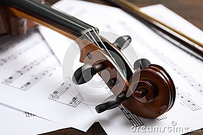 Beautiful violin and note sheets on table Stock Photo