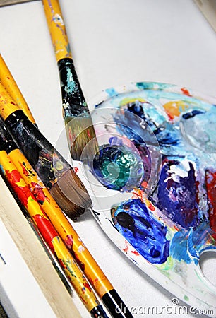 Art palette and paintbrushes Stock Photo