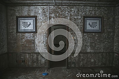 A beautiful wall with a mosaic in an abandoned house. Shabby walls. Low light. An old abandoned manor. Stock Photo