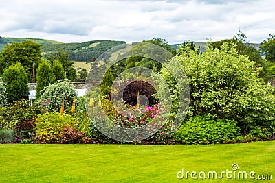 Beautiful walled, victorian garden with variety of flowers and trees Stock Photo