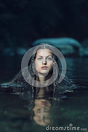 Beautiful water nymph in dark cyan stream Stock Photo