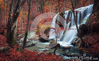 Beautiful waterfall in autumn forest in crimean mountains at sun Stock Photo