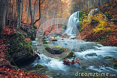 Beautiful waterfall in autumn forest in crimean mountains at sun Stock Photo