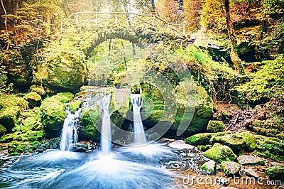 Beautiful waterfall in autumn forest Stock Photo