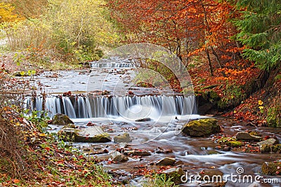 Beautiful waterfall in forest, autumn landscape Stock Photo