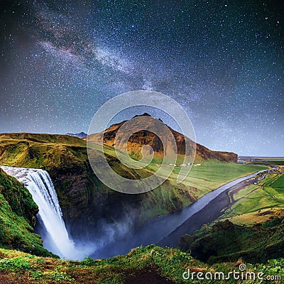 Beautiful waterfall. The starry sky and the Milky Way. Iceland. Stock Photo