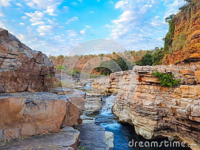 A beautiful waterfall surrounded by rocky mountain at Chidiya Bhadak, Indore, Madhya Pradesh, India Stock Photo