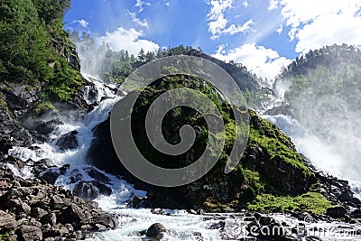 Beautiful Latefossen waterfall with two adventurous goats in Norway Stock Photo