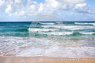 Beautiful waves on blue ocean with white foam blue sky with clouds background Stock Photo