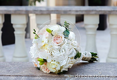 Beautiful wedding bouquet on a vintage marble banister Stock Photo