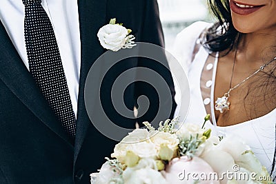 Beautiful wedding couple holding hands. It`s such an exciting moment. Vintage wedding dress and men`s costume Stock Photo