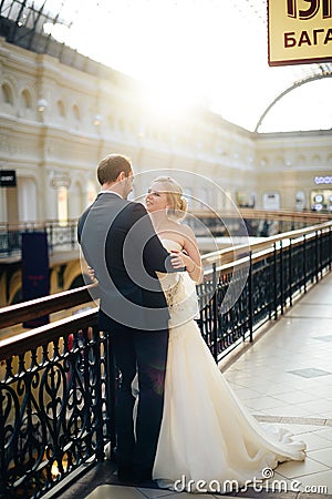 Beautiful wedding couple in Moscow, the bride and groom in a white dress in the interior, happy new family Stock Photo