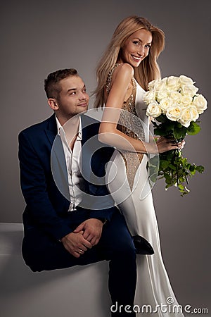 https://thumbs.dreamstime.com/x/beautiful-wedding-couple-posing-studio-blonde-women-white-dress-handsome-men-suit-love-content-59238327.jpg