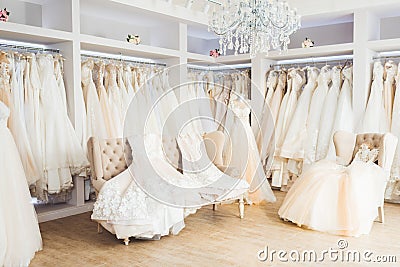 Beautiful wedding dresses on hangers in wedding atelier Stock Photo