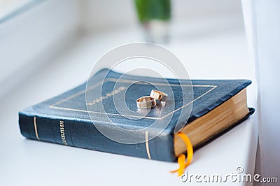 Beautiful wedding rings on blue bible bookmark Stock Photo