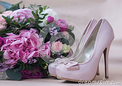 Beautiful wedding shoes with high heels and a bouquet of colorful flowers Stock Photo