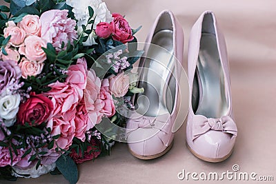 Beautiful wedding shoes with high heels and a bouquet of colorful flowers Stock Photo