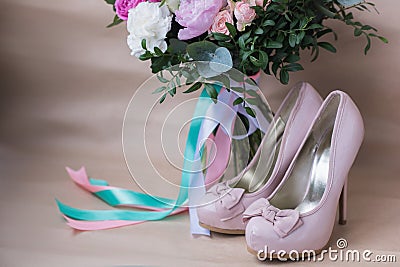 Beautiful wedding shoes with high heels and a bouquet of colorful flowers Stock Photo