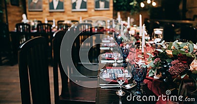 Beautiful weding table decoration with red fresh flowers and candles Editorial Stock Photo