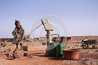 Beautiful West Africa Infant Working with Fresh Water for a dehydration concept Stock Photo