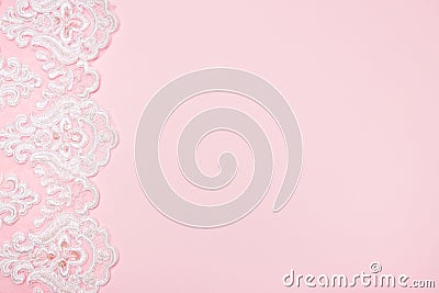 Beautiful white floral lace on a pink background Stock Photo