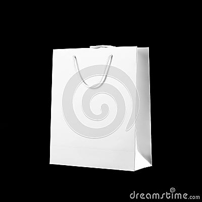 Beautiful white gift bag. Close up. Isolated on black background Stock Photo