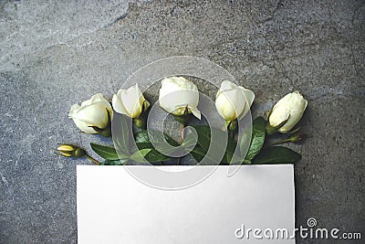 Beautiful white roses and elegant blank paper stationery photo mockup. High resolution spring presentation for art design. Stock Photo