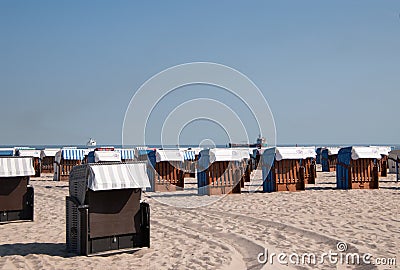 Closed beach chair huts on white sand beach in Warnemunde German Editorial Stock Photo