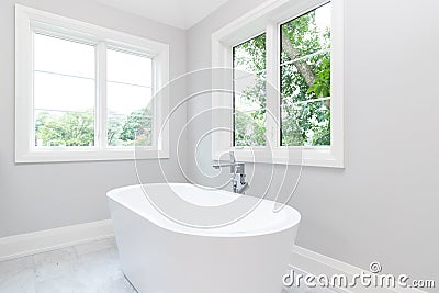 A white standalone tub in a luxury bathroom. Stock Photo