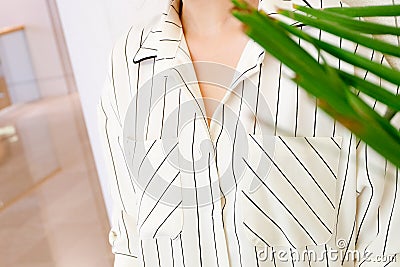 Beautiful white striped woman blouse shirt fashion details close up. minimal comfortable trendy fashion style. Stock Photo