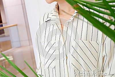 Beautiful white striped woman blouse shirt fashion details close up. minimal comfortable trendy fashion style. Stock Photo