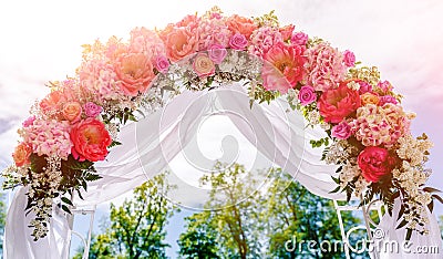 Beautiful white wedding arch outdoors Stock Photo