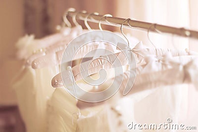 Beautiful white wedding dresses made of silk on hangers Stock Photo