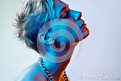 Beautiful white woman with short colour hair and blue light Stock Photo