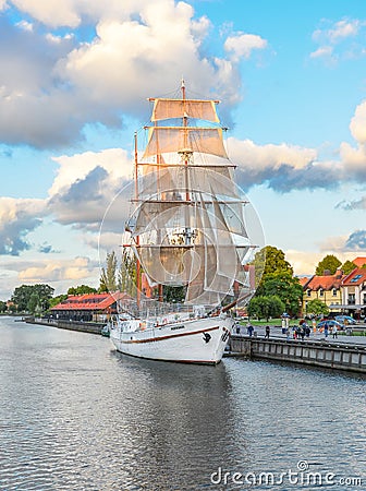 Beautiful white yacht - famous symbol of Klaipeda. Restaurant on sailing boat, Dane river a Editorial Stock Photo
