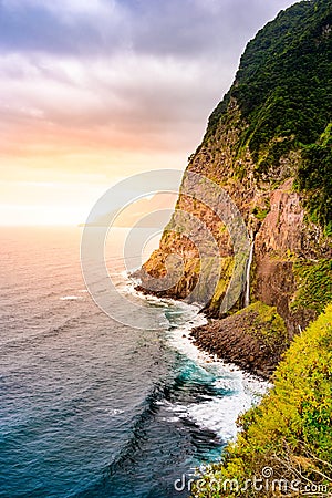 Beautiful wild coast scenery view with Bridal Veil Falls (Veu da noiva) at Ponta do Poiso in Madeira Island. Near Porto Moniz, Stock Photo